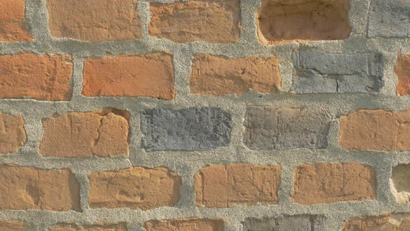 Brick wall details 4K 2160p UHD panning video - Bricks in the wall lighted 4k 3840X2160 UHD footage alt