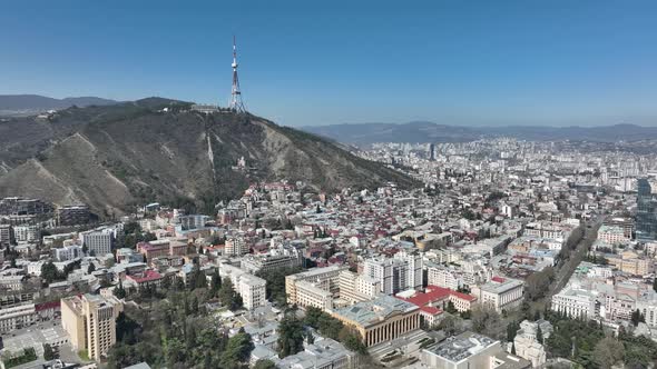 Aerial view of center of Tbilisi under Mtatsminda mountain, Georgia 2022 spring alt