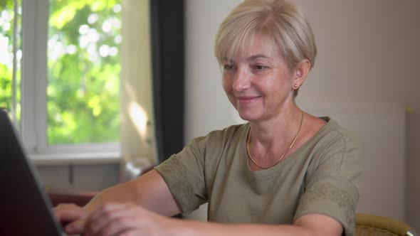 Caucasian Blonde Adult Women is Studying with Laptop