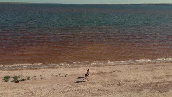 Two People Running By Sand Beach Coastline Sand Bar at Mykolaiv Region Ukraine alt