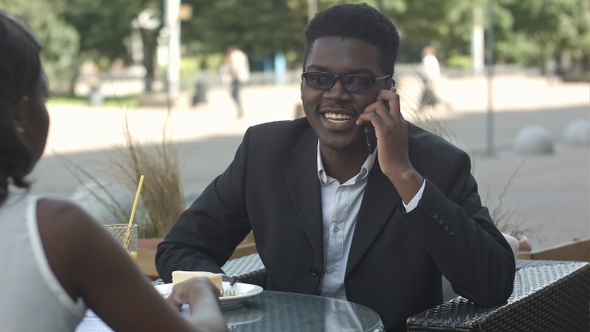 Pleasant Afro American Man Having Phone Call During Work