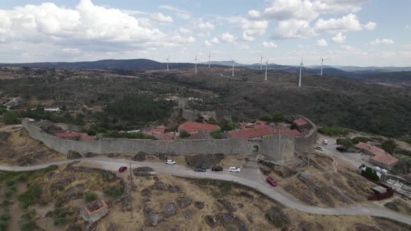 Portugal, Sortelha defensive wall and towering castle. Wind farm at distance