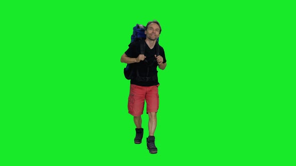 Smiling Hiker Man with Backpack Going Camping in Nature against Green Screen Background