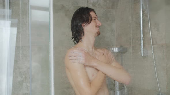 Slow Motion of Handsome Guy Washing with Soap Foam in Shower at Home alt