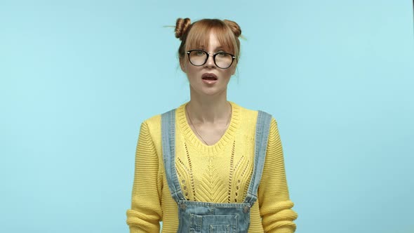 Hipster Female Model in Glasses and Yellow Sweater Judging Something Bad Showing Thumbsdown and