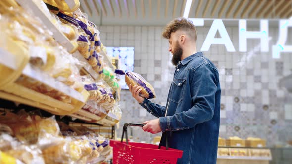 Male Visitor is Buying Bread in Bakery in Supermarket alt