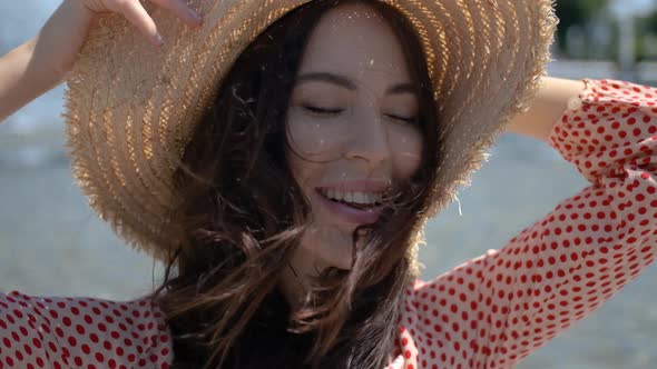 Beautiful Woman Posing Next To City Fountain in Summer Time alt