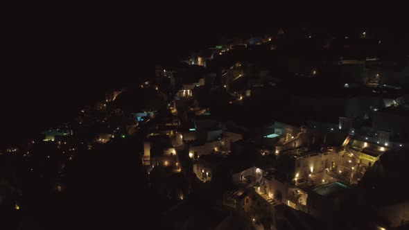 Aerial night view above village on Santorini island, Greece. alt