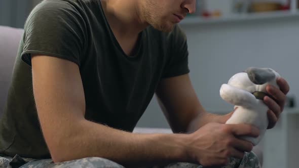 Thoughtful Serviceman Holding Toy in Hand, Young Father Missing Child, Nostalgia alt