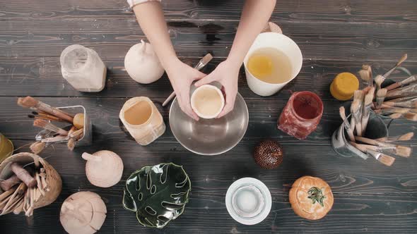 Top View Potter Making Ceramic Bowls and Plates Woman Hands Painting Color Handmade Traditional alt