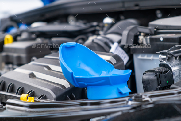 Blue cap of the reservoir for windshield washer fluid, close up