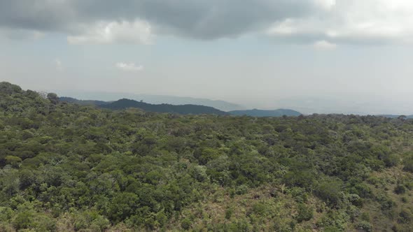 Lush green south-easterner landscape of Bokor Mountains in Kampot, Cambodia - Aerial Panoramic shot alt