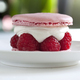 Delicious French macaroon on a white plate in a tea room - PhotoDune Item for Sale