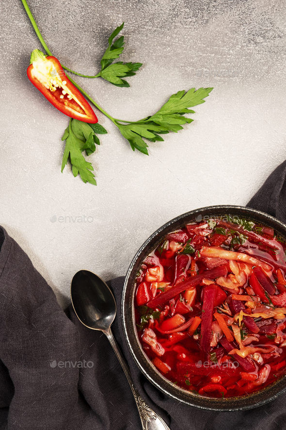 Homemade red cabbage soup with beets, vegetables and herbs Stock Photo