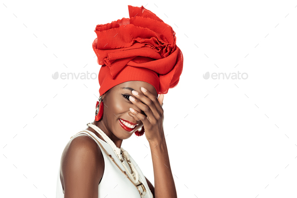 young african american woman in wire head wrap covering face with hand isolated on white