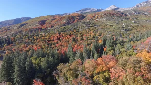 A drone flies over the rocks and slopes of  Dry Creek Trailhead in Alpine, Utah as leaves change int alt