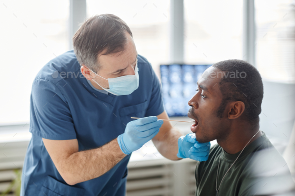Putting Swab Stick Into Patients Mouth