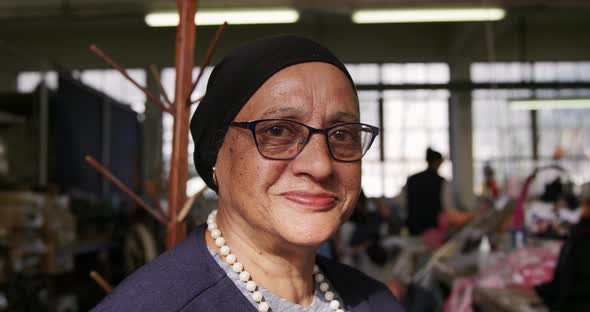 Mixed race woman working at a hat factory alt