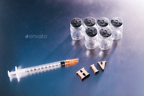 New AIDS treatment, vaccination with syringe with new vaccine, letters HIV on medical background.