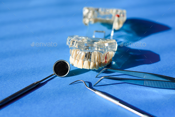 Dental tools for healing dentures, jaw isolated on a dentist doctor\'s table.