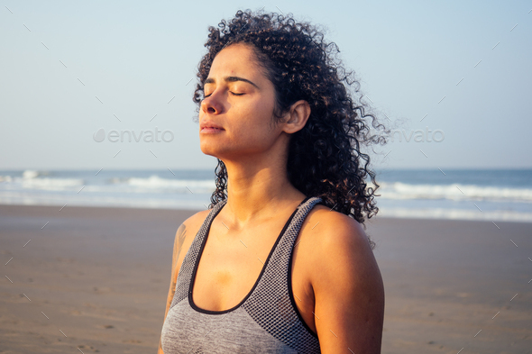 afro america woman with curly hair and closed eyes deep breathing