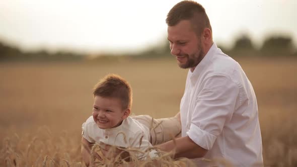 Father Playing with His Son in Wheat Field