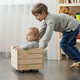 Two brothers playing and riding in wooden toy box. Children playing and having fun at home - PhotoDune Item for Sale