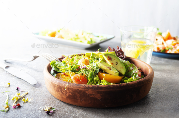Salad with avocado, tomatoes and fresh greens - Stock Photo - Images