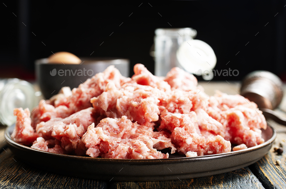 Raw mince lamb, ground mutton meat with herbs on a plate. - Stock Photo - Images