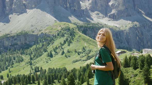 Portrait of young woman in mountain landscape, Alta Badia, Italy