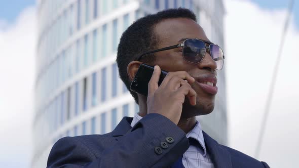 Young Handsome Businessman Talking On Mobile Phone In The City alt