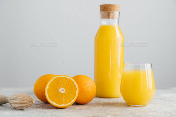 Jug of orange juice and orange fruits isolated on white, Stock image