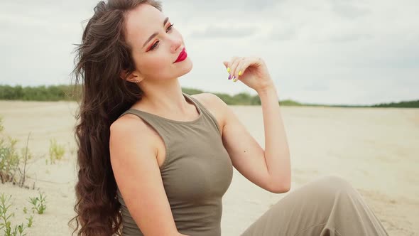 Pretty Woman Touching Hair on Beach alt