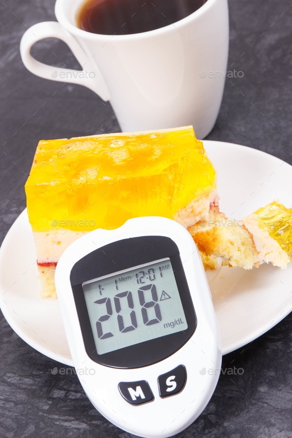 Glucometer with high sugar level, creamy fruit cake with jelly and cup of coffee