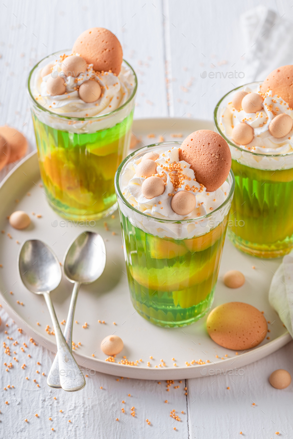 Homemade green jelly made of peaches and whipped cream.