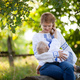 Mother breastfeeding baby son outdoors. Woman and her son wearing Ukrainian style shirts. - PhotoDune Item for Sale