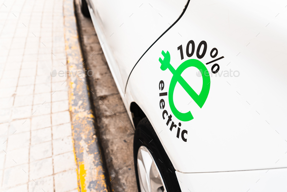 100% electric white car, promotion of sustainable mobility with electric recharging car, design.