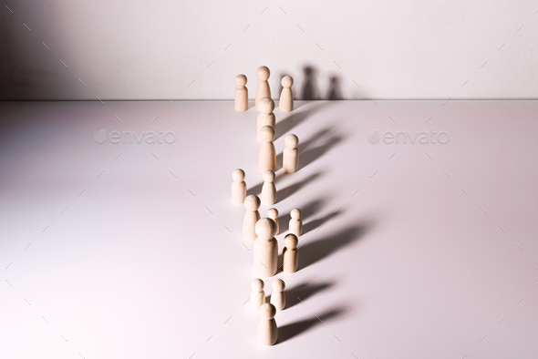 Small group of separated people seen from above represented anonymous with wooden figures