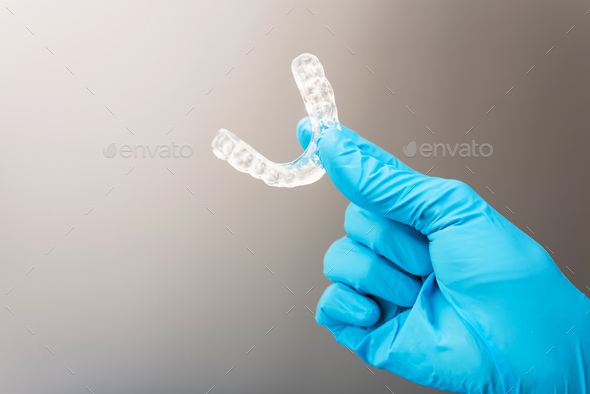 Dentist holds occlusal splint used to reduce nighttime bruxism. Stock ...