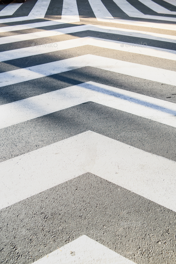 White converging lines on a black asphalt background in an unusual crosswalk. - Stock Photo - Images