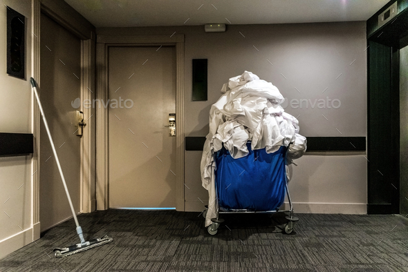Trolley with dirty clothes in the corridor of a hotel.