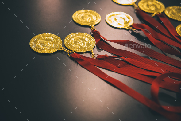 Olympic gold medals on a black table to reward the winners.