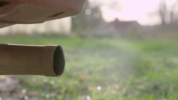 CLOSEUP exhaust, engine starting in 150fps SLOW MOTION, natural light, suburban alt