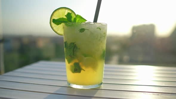 Tropical Cocktail Decorated with Fresh Lime and Mint Leaves