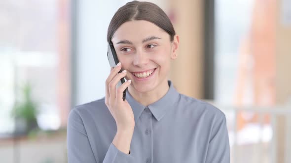 Portrait of Young Latin Woman Talking on Smartphone alt