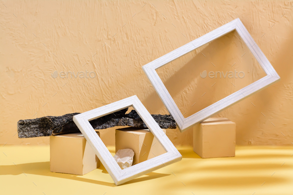 Modern abstract life style background: concrete, blank photo frames, stones and tree bark