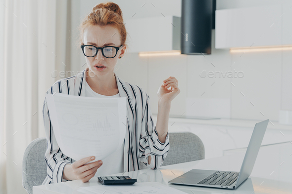 Busy redhead woman financier makes business financial accounting calculates something