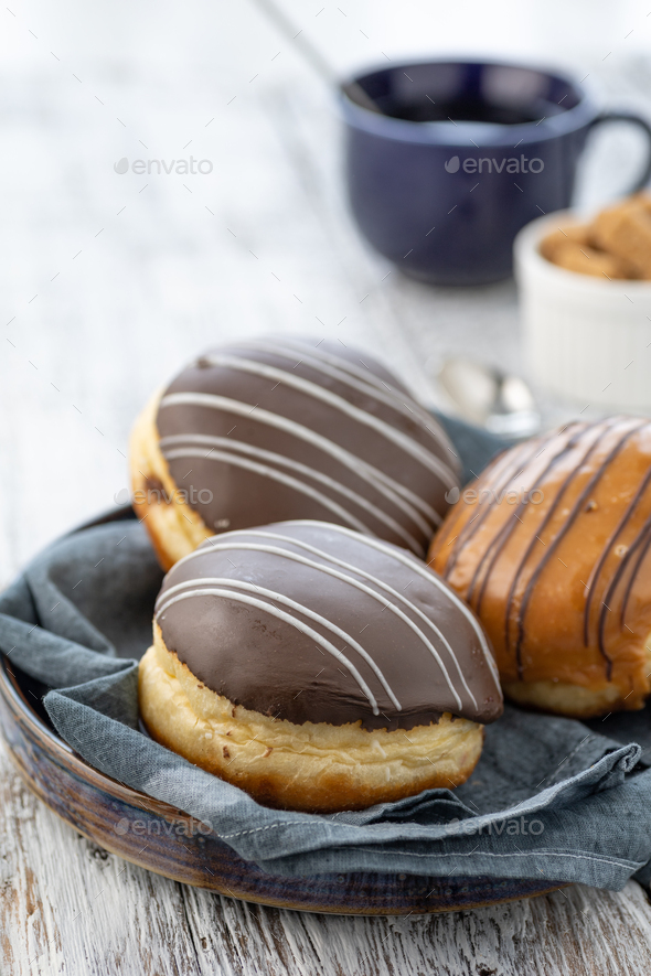 Donut or bun made from sweet yeast dough stuffed with chocolate and icing.