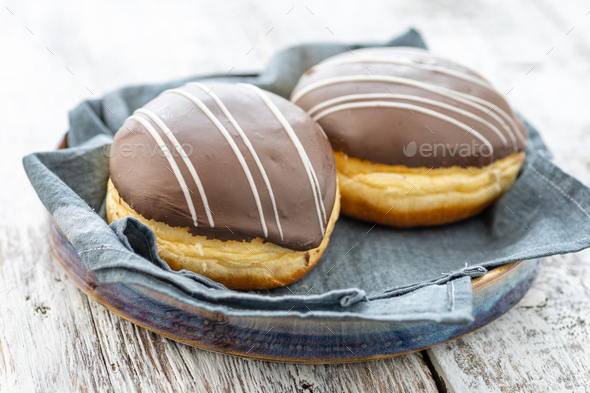 Donut or bun made from sweet yeast dough stuffed with chocolate and icing.