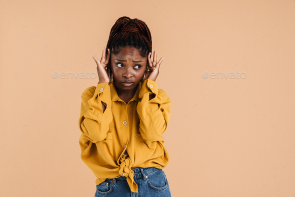 Young Black Woman With Headache Frowning While Rubbing Her Temples